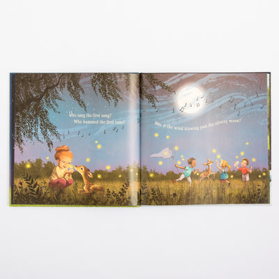 Open book with illustrations of children playing in a field and a dog.