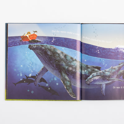 Open book showing a whale and a boat on an underwater scene